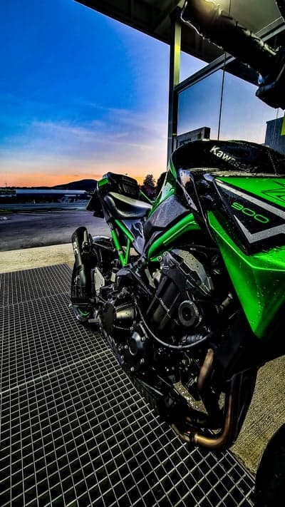 Green Kawasaki Z900 Motorcycle Under Sunset Sky
