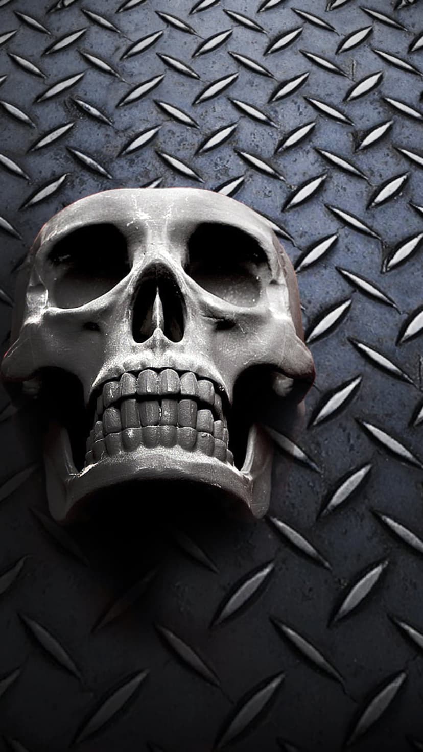Human skull resting on a dark diamond plate steel surface with high-contrast lighting and industrial textures.
