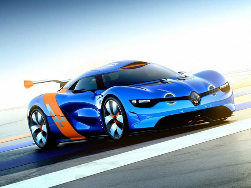Blue Renault Alpine A110-50 concept car with orange racing accents on a paved track under a bright clear sky.