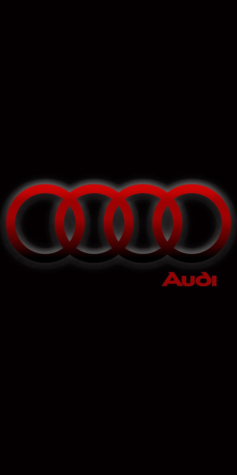 Red interlocking Audi rings glow softly against a black backdrop with the brand name positioned below.