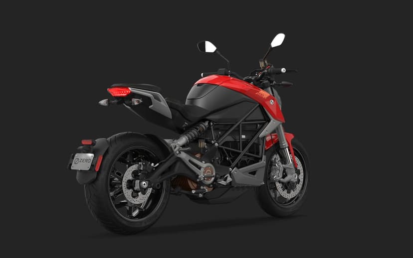 Rear view of a red and black electric motorcycle with exposed mechanics against a dark gray background.