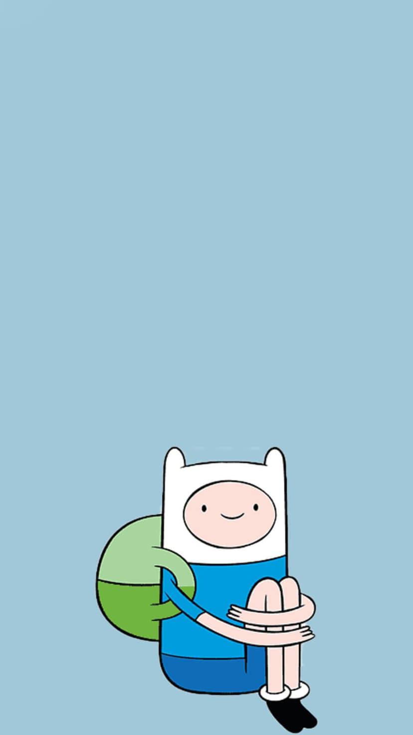 Finn the Human wears a white hat and blue shirt while sitting on a solid light blue background with arms on knees.
