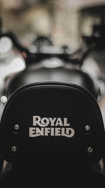 Classic Silver Royal Enfield Logo on Black Leather Seat