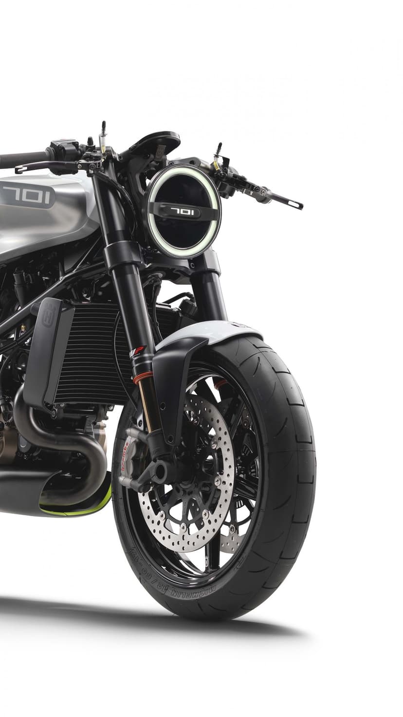 Front view of a Husqvarna Vitpilen 701 motorcycle with a round LED headlight and WP forks on a white background.