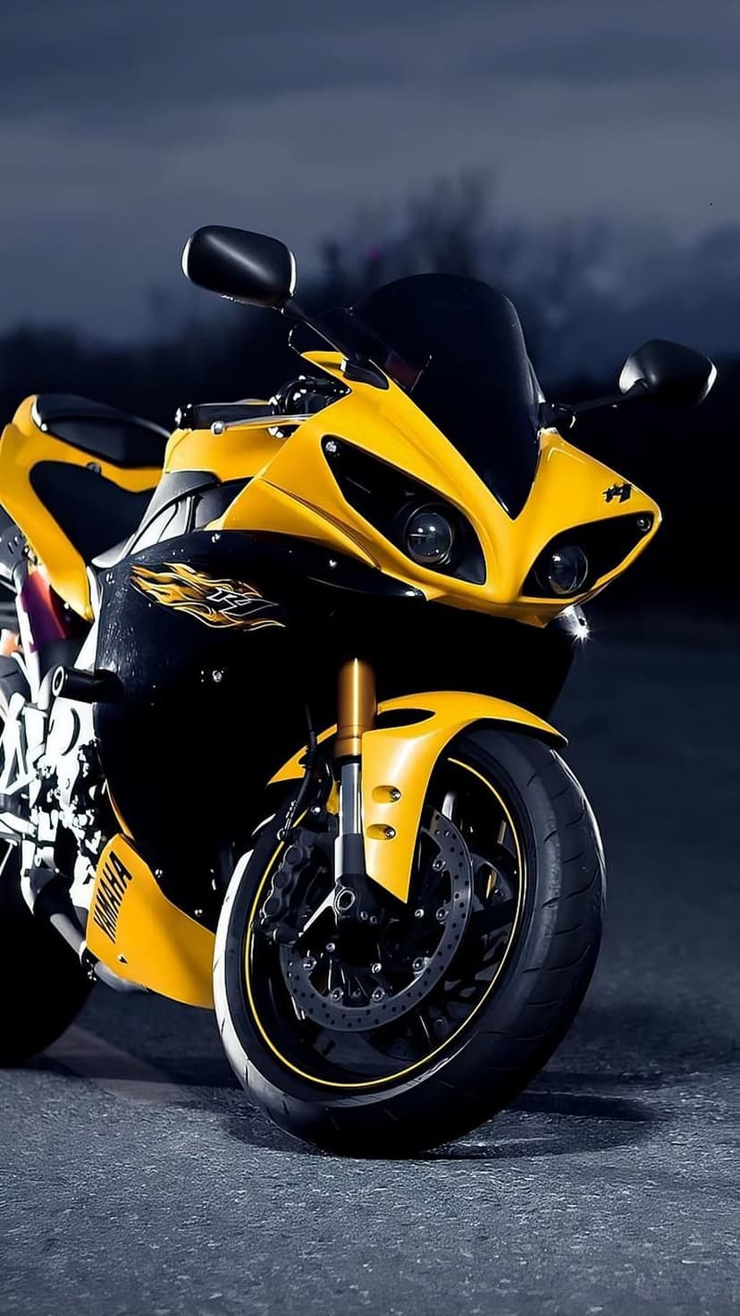 Yellow Yamaha sportbike front view showing illuminated LED headlights, black fairings, and a dual-disc brake wheel.