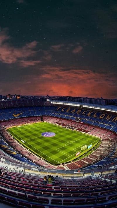 Camp Nou Stadium at Dusk with Stars and Clouds