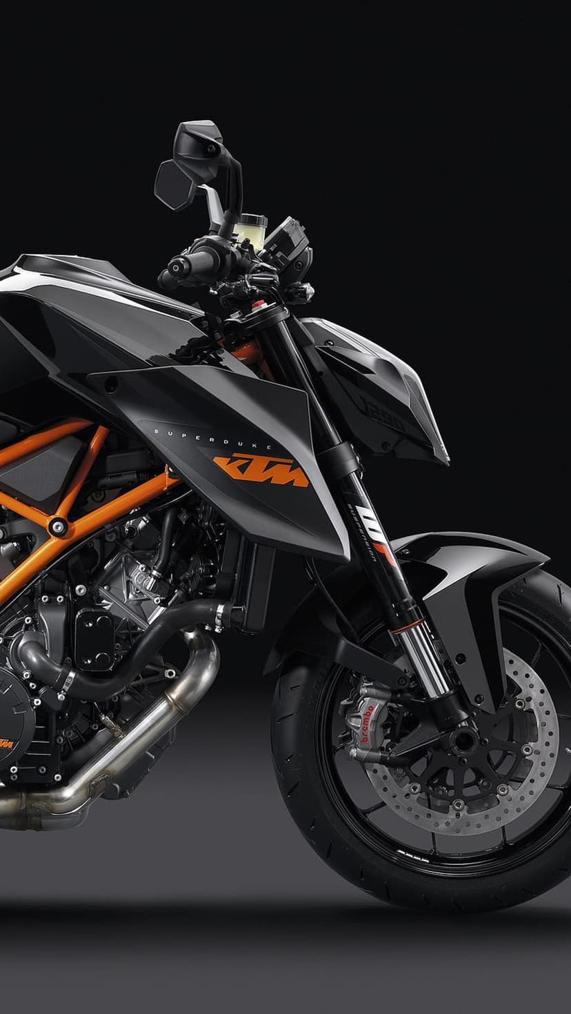 KTM Supermoto front detail showing a black fairing, orange trellis frame, and high-performance engine parts.