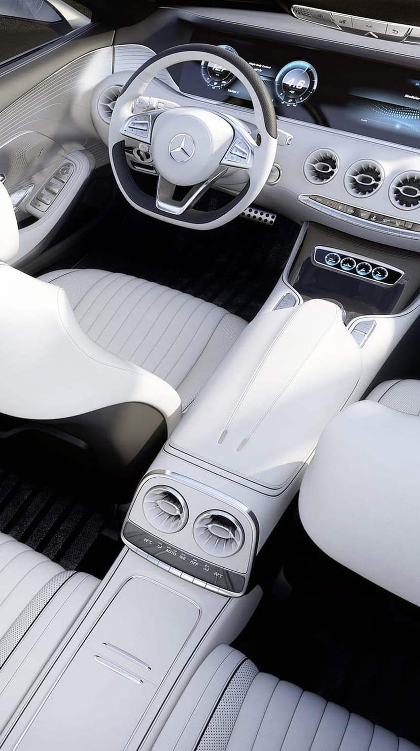 White Mercedes steering wheel and digital dashboard with ivory leather seats in a high-end luxury vehicle cabin.