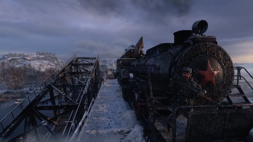 A soldier with a rifle stands on a steam locomotive with a red star on a snowy bridge under a dark sky.
