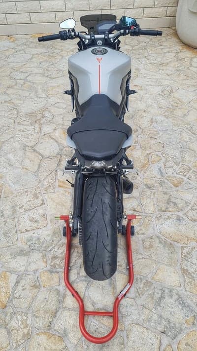 Rear View of Silver Yamaha MT-09 Motorcycle on Red Stand