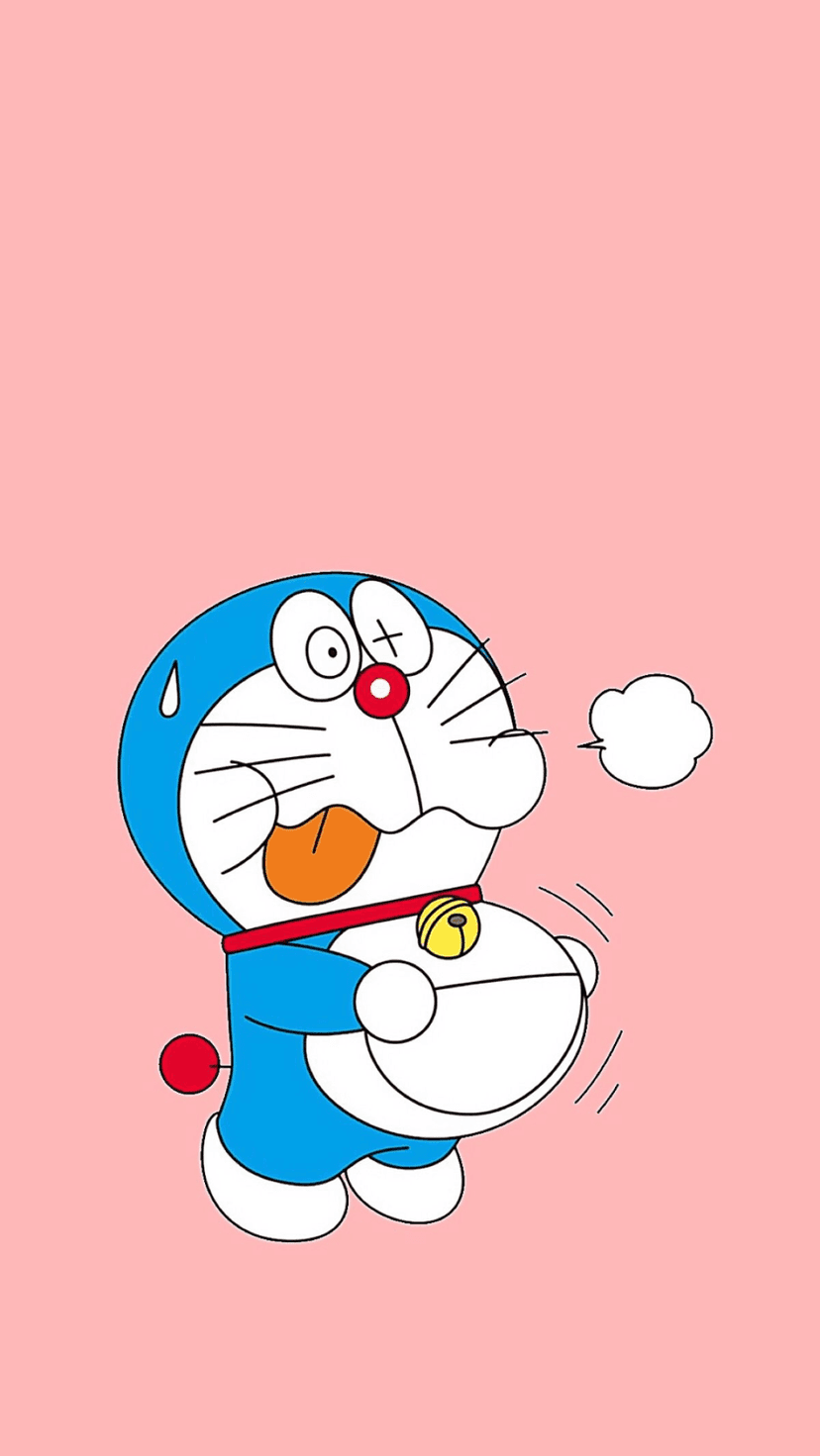 Doraemon holding a round stomach with a pained expression on a solid pastel pink background with soft shadows.