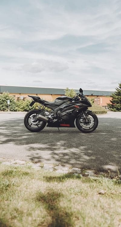 Black Yamaha Sportbike Parked Outdoors Under Cloudy Sky