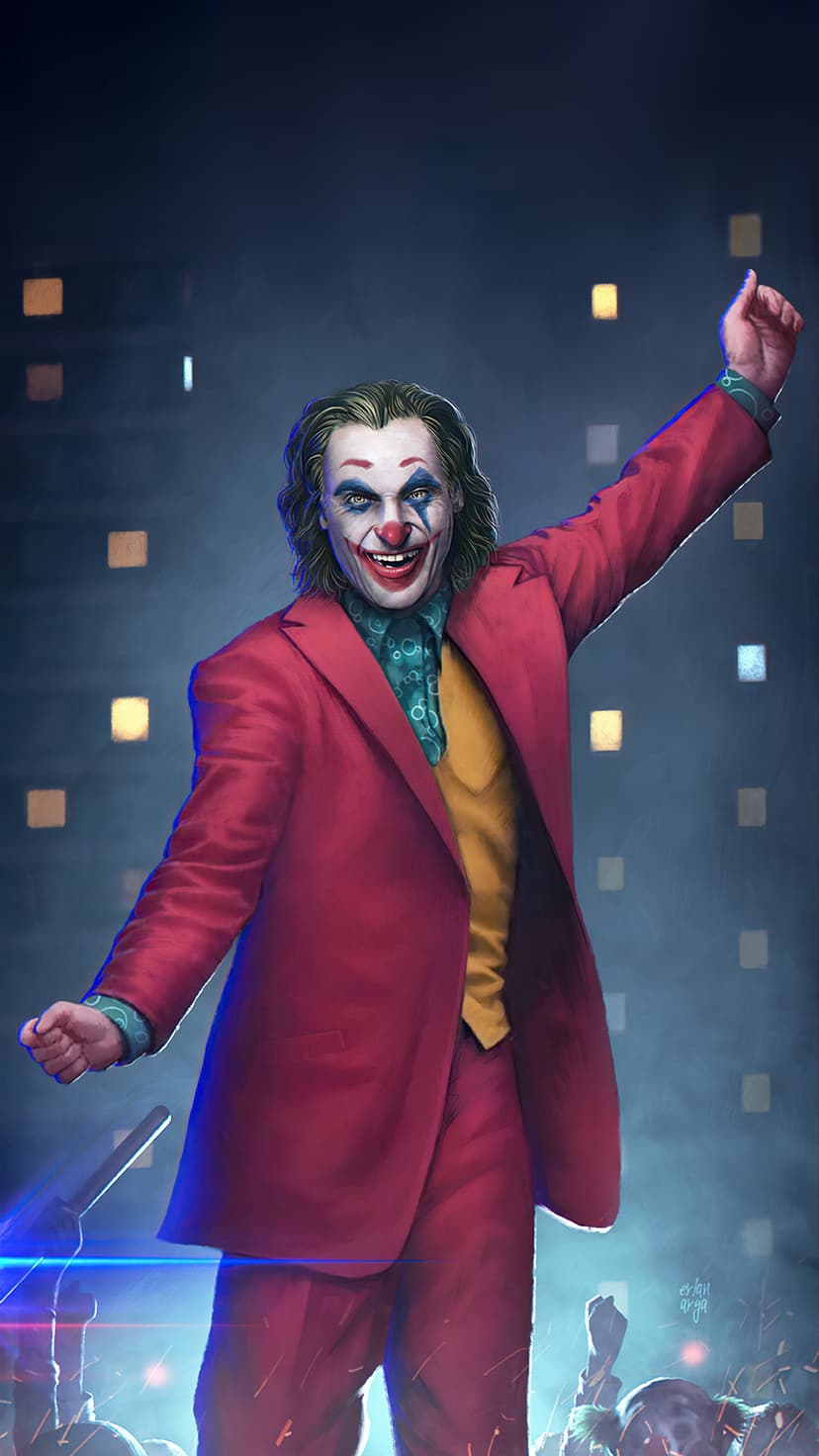 Joker in a red suit raises one arm victoriously amidst blurred city lights and glowing urban bokeh at night.