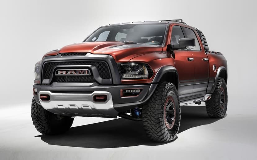 Aggressive copper RAM Rebel TRX concept truck with off-road tires and wide body kit in a clean white studio setting.