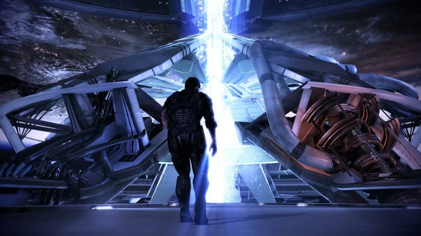 Commander Shepard walks toward a towering blue energy beam inside a massive futuristic structure in space.