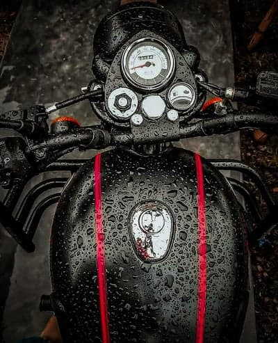 Rain-Drenched Black Motorcycle with Red Accents