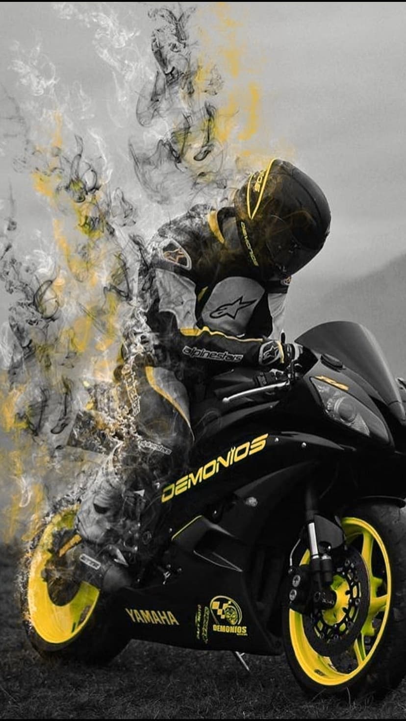 Motorcyclist in full gear on a Yamaha sportbike surrounded by thick yellow and black swirling smoke plumes.