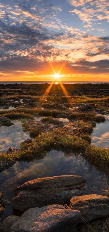 Tidal Pools Reflecting a Fiery Dawn