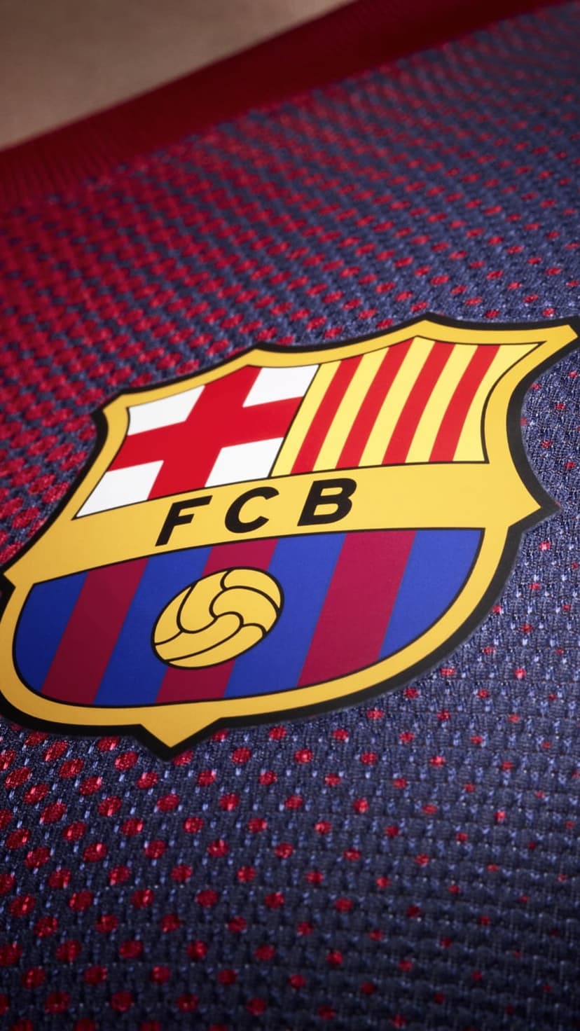 FC Barcelona crest with St. George's Cross and Catalan stripes embroidered on a blue and red textured sports jersey.