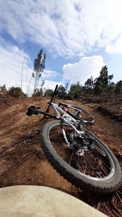 Mountain bike on dirt track under cloudy sky