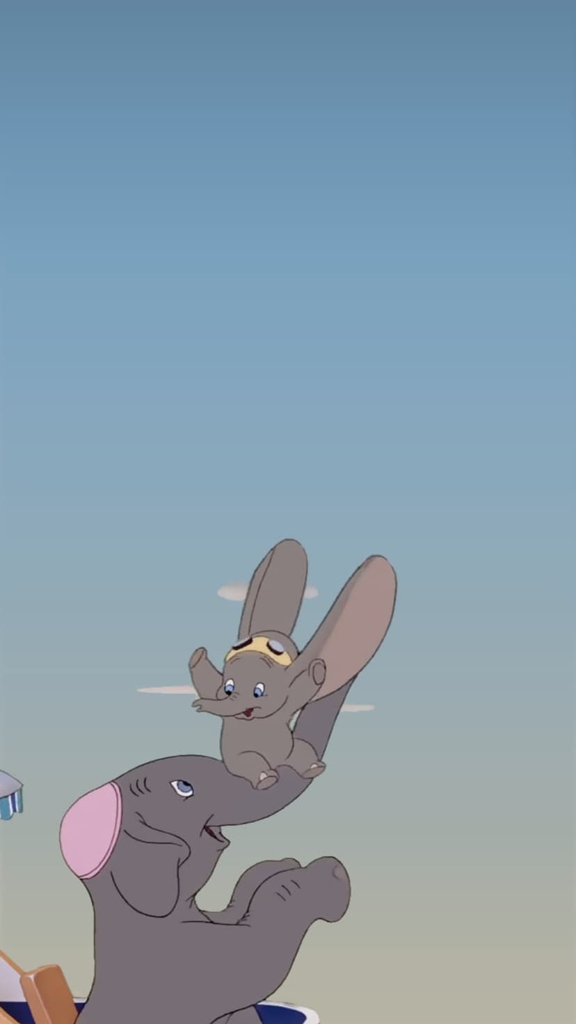Dumbo the elephant flies through a bright blue sky with Timothy Mouse perched upon his trunk over soft clouds.
