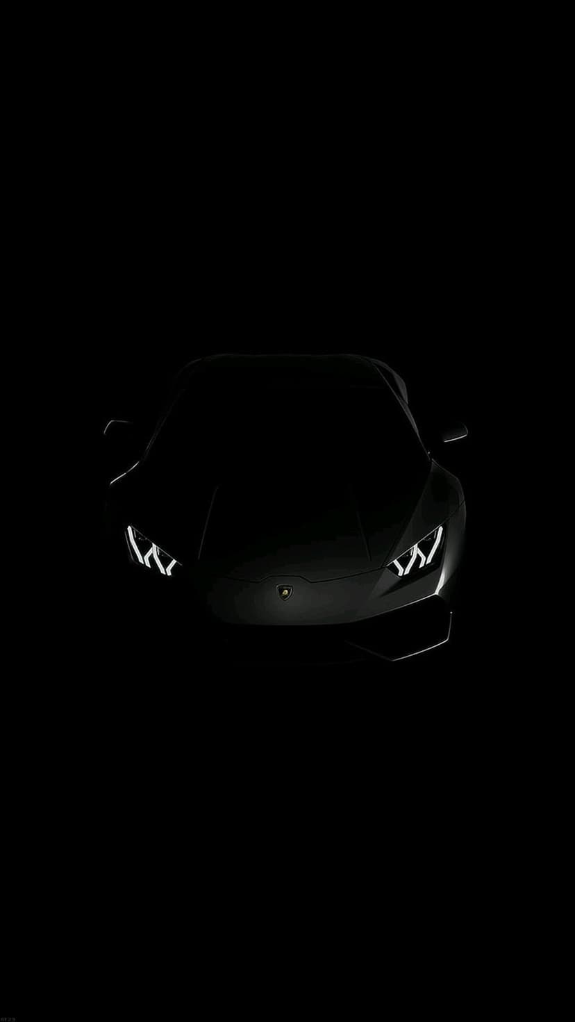 Lamborghini supercar with glowing LED headlights emerges from a dark shadow in a minimalist portrait composition.