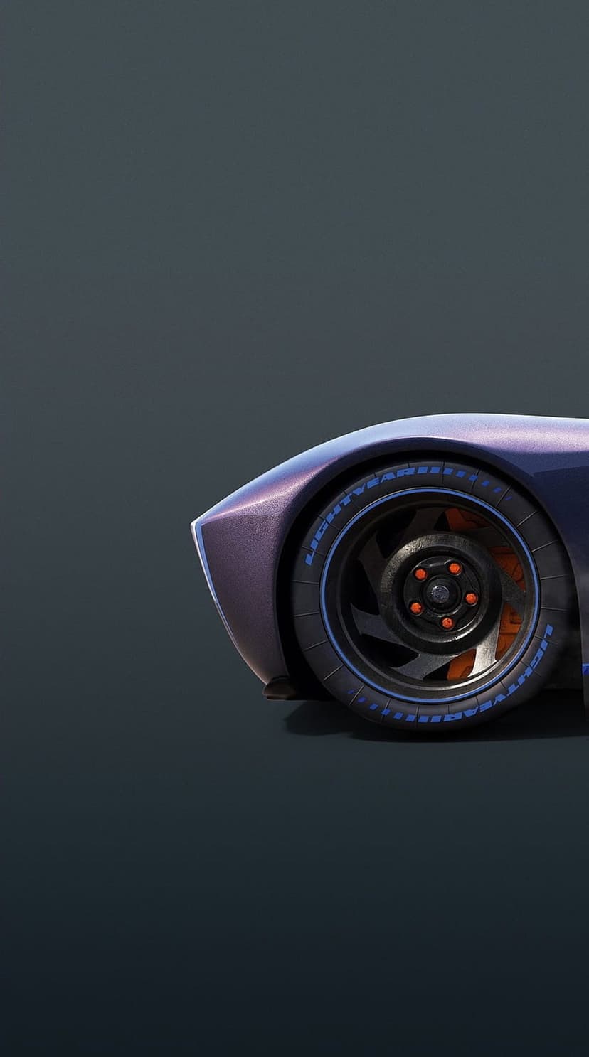 Metallic purple car fender over a black rim with orange brake calipers and blue lettering on the tire sidewall.