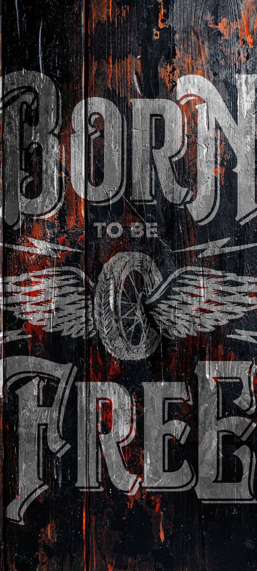 Winged motorcycle wheel with Born to Be Free text on a distressed brown wood background with grunge textures.