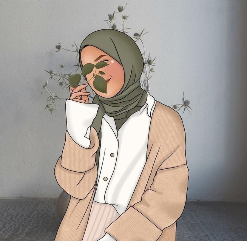 Woman wearing a green hijab and beige cardigan holds two leaves over her eyes against a gray wall with sprigs.