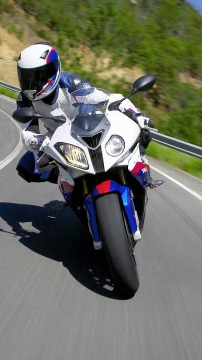 Motorcyclist in BMW Gear Rips Through Scenic Mountain Road