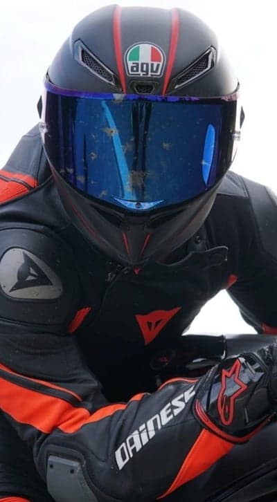 Motorcyclist in AGV helmet and Dainese suit