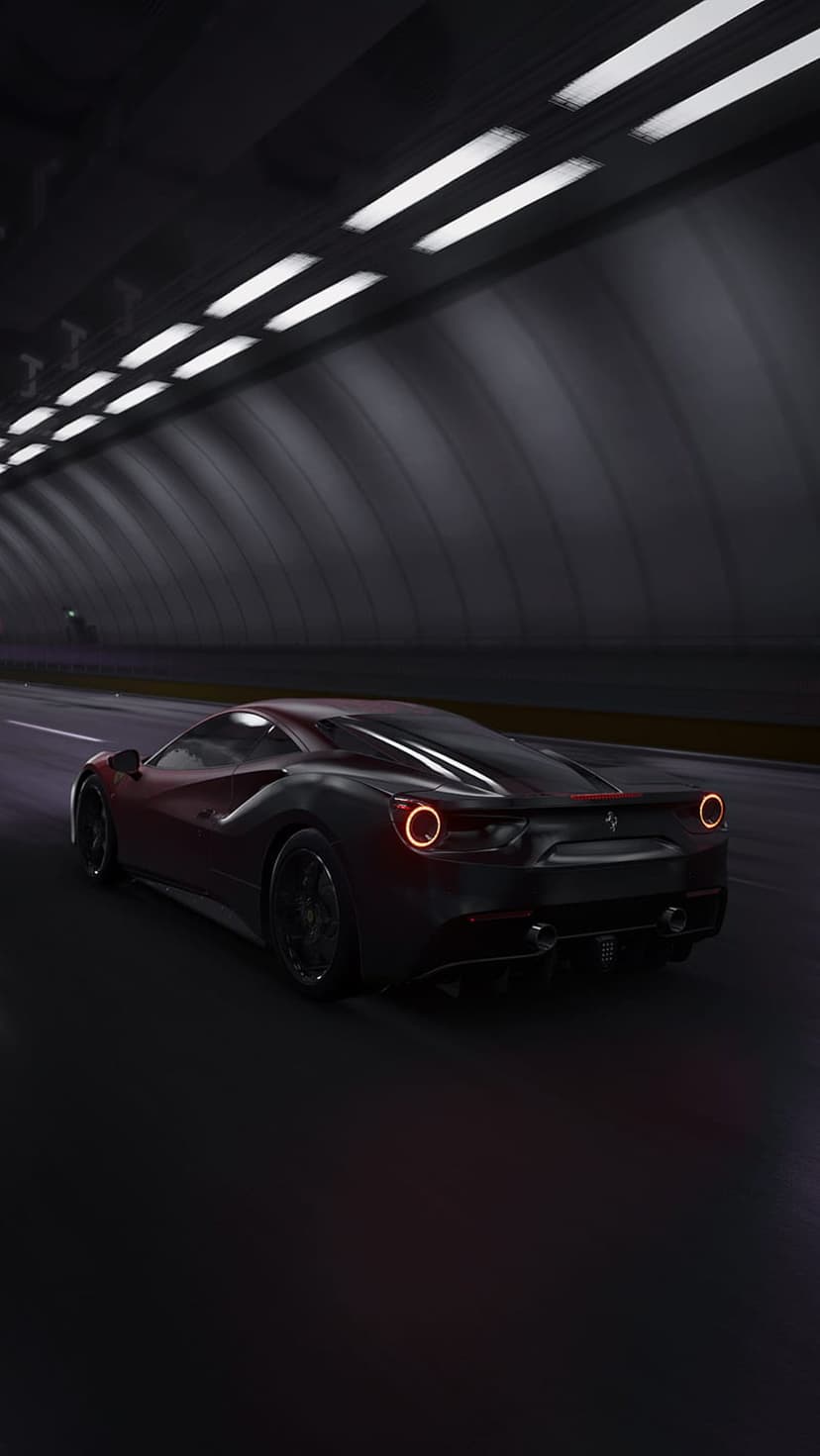 Ferrari sports car with glowing red taillights accelerates through a dark tunnel under white overhead lights.