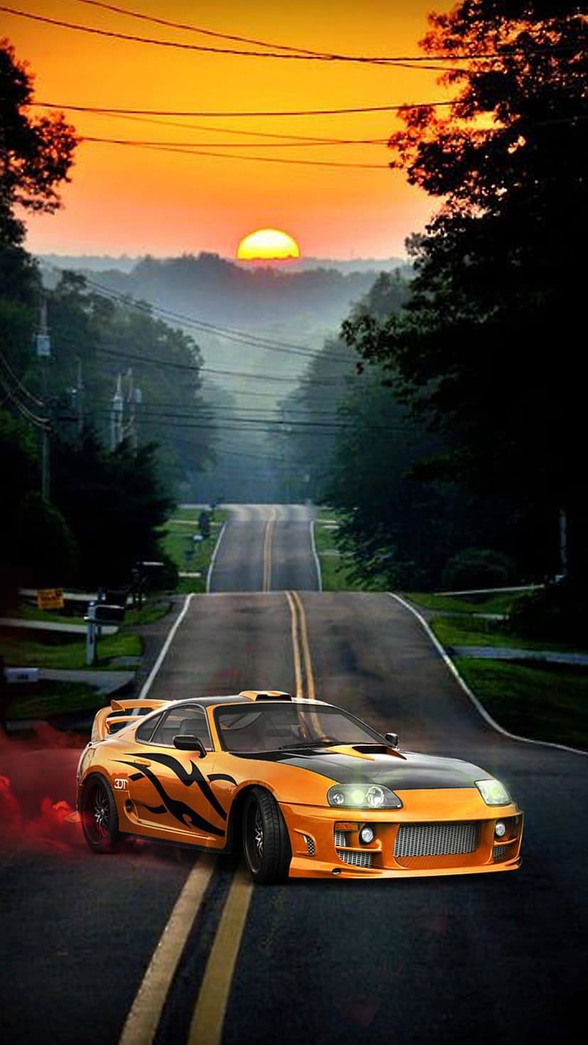 Orange Toyota Supra with flame decals drifts on a road at sunset, releasing red smoke from its spinning tires.