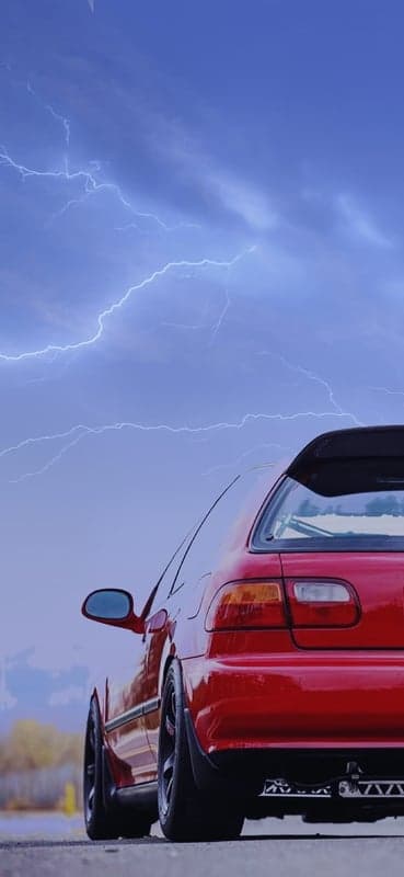 Red Honda Civic in Thunderstorm with Lightning