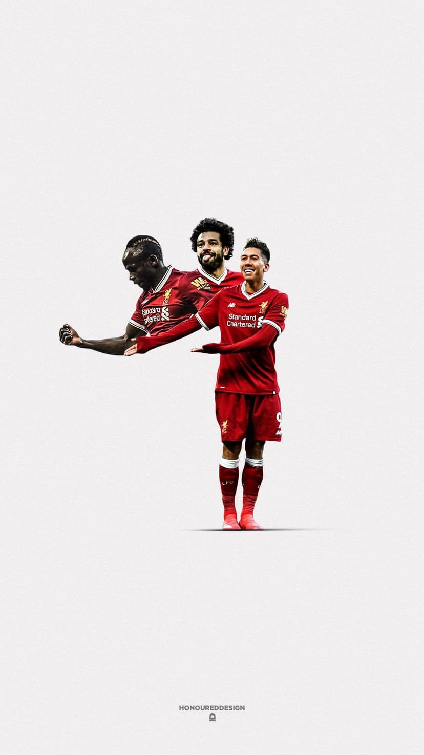 Roberto Firmino in a red kit stands centered before blurred figures of Salah and Mane on a white background.