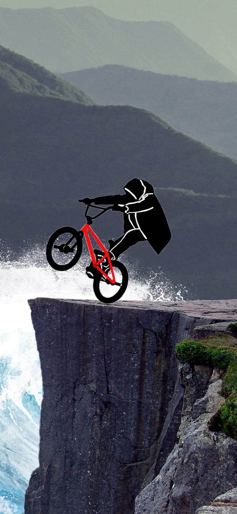 BMX athlete in a hoodie performs a bike stunt on a steep cliff edge overlooking misty mountains and ocean waves.