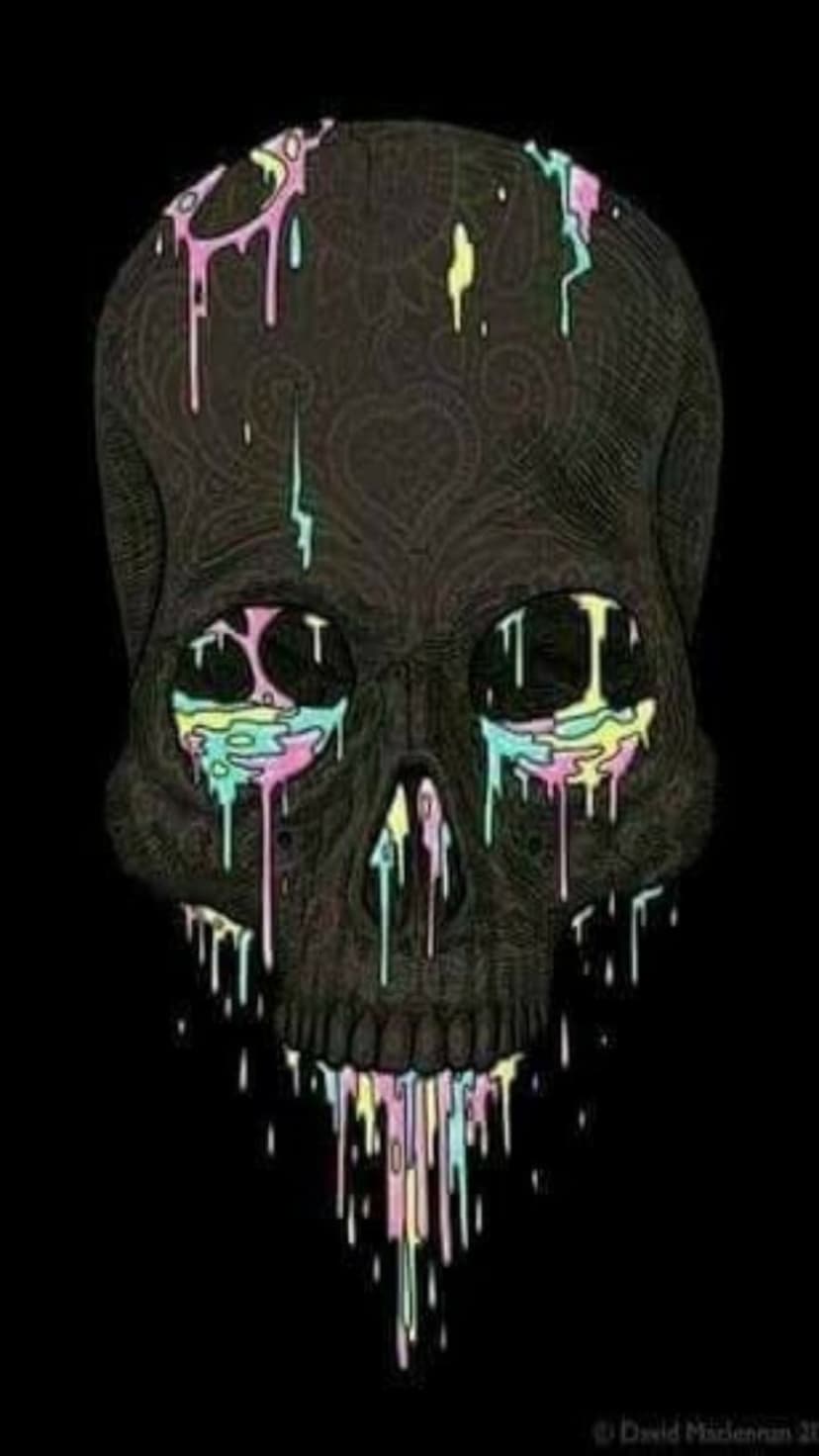Weathered human skull with vibrant pink, yellow, and blue paint dripping from eye sockets onto a black surface.