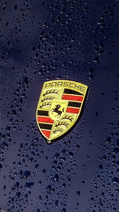 Porsche Badge with Raindrops on Navy Hood Mobile Theme