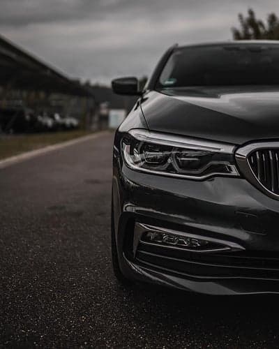 Stealth Black Luxury Sedan Headlight Phone Wallpaper