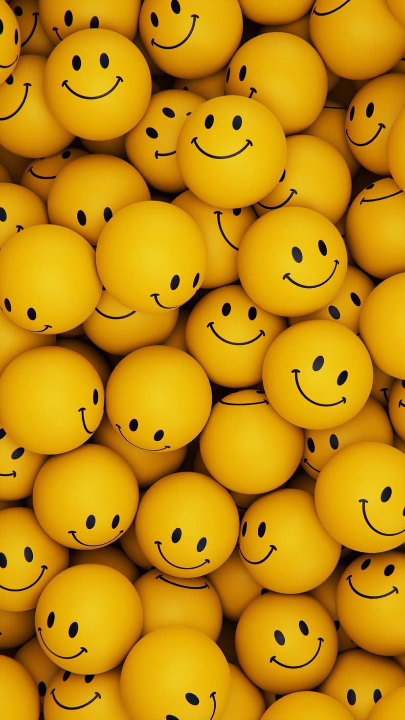 Yellow smiley face balls packed tightly together create a joyful texture of round emoji spheres in bright light.