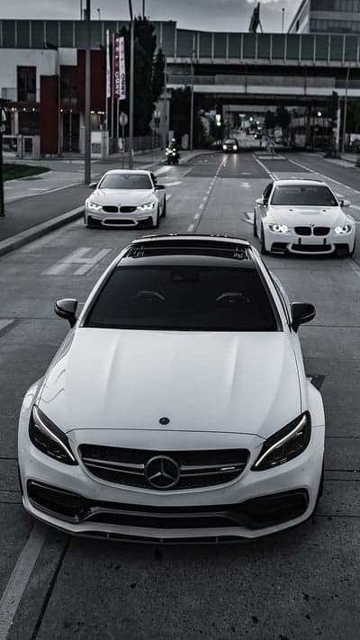 Trio of White Luxury Cars on City Street Phone Wallpaper