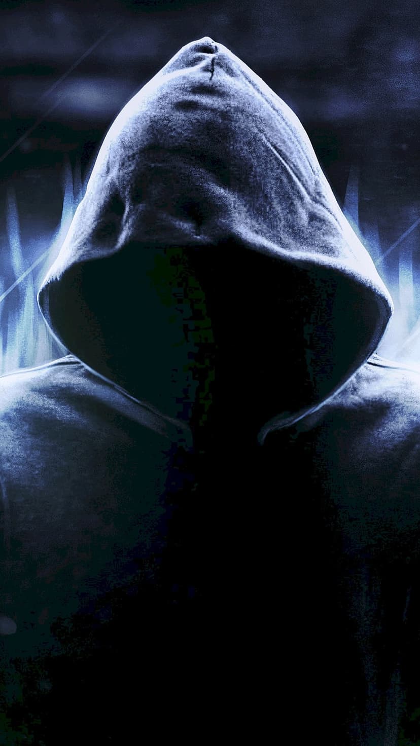 Hooded person wearing a glowing skull mask stands against a blurry neon city street at night with misty lighting.