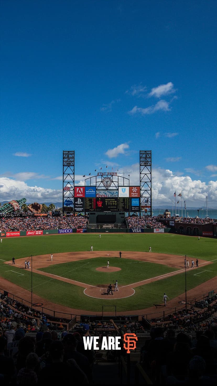 San Francisco Giants baseball field with players and fans under a blue sky for a vertical phone background.