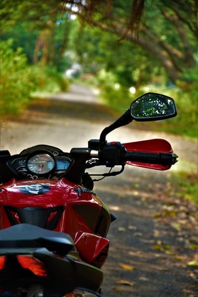 Motorcycle handlebar and mirror on scenic road