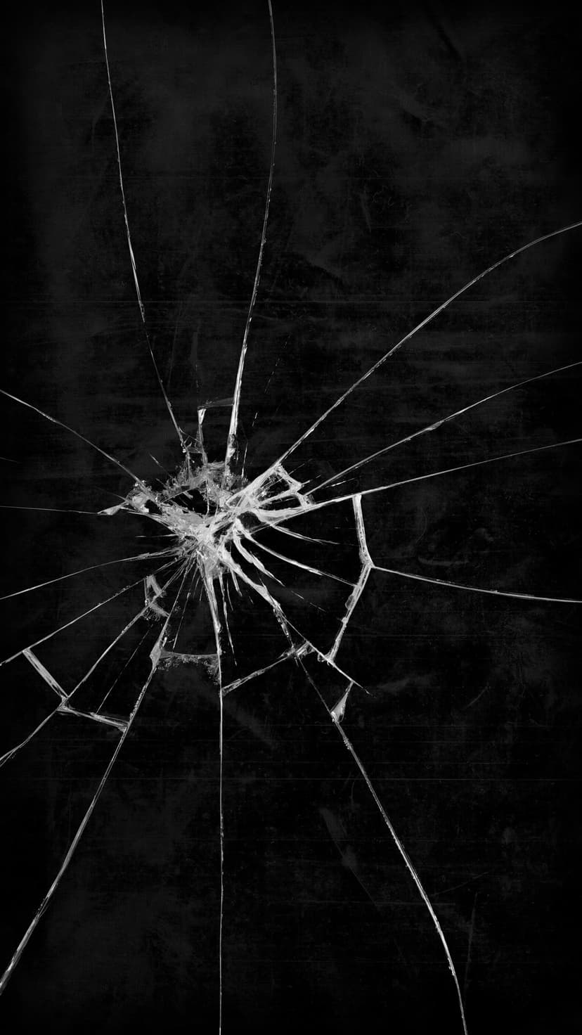 Shattered glass fractures radiating from a central impact point across a dark, reflective monochrome surface.