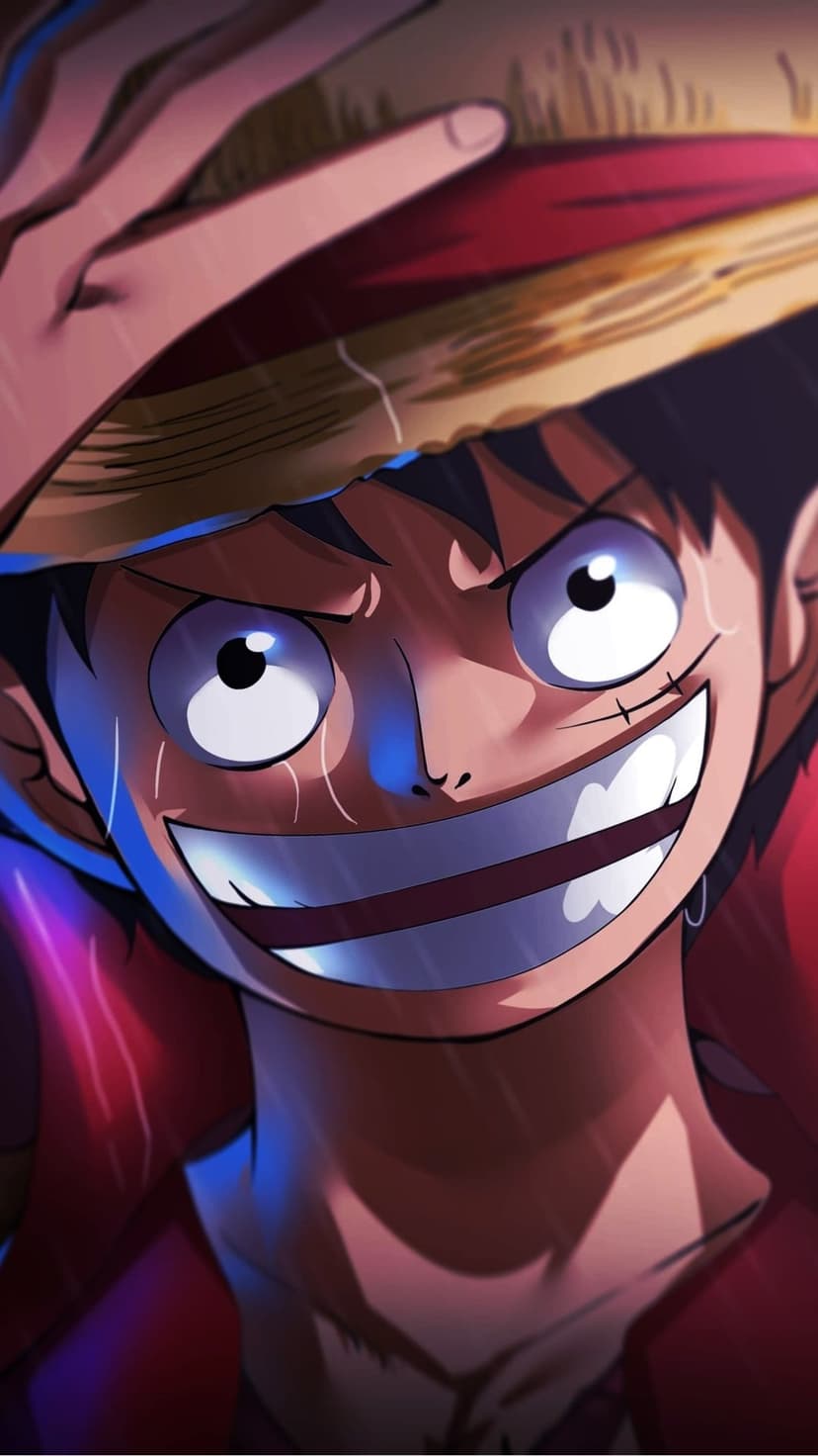 Monkey D. Luffy smiles broadly with tears in his eyes and sweat on his brow while wearing his iconic straw hat.