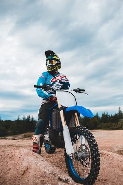 Motocross Rider in Blue Gear on Dirt Bike