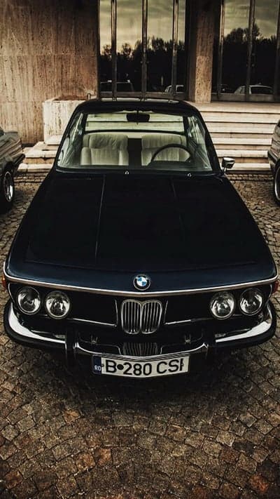 Classic BMW 280 CSI parked on cobblestone street