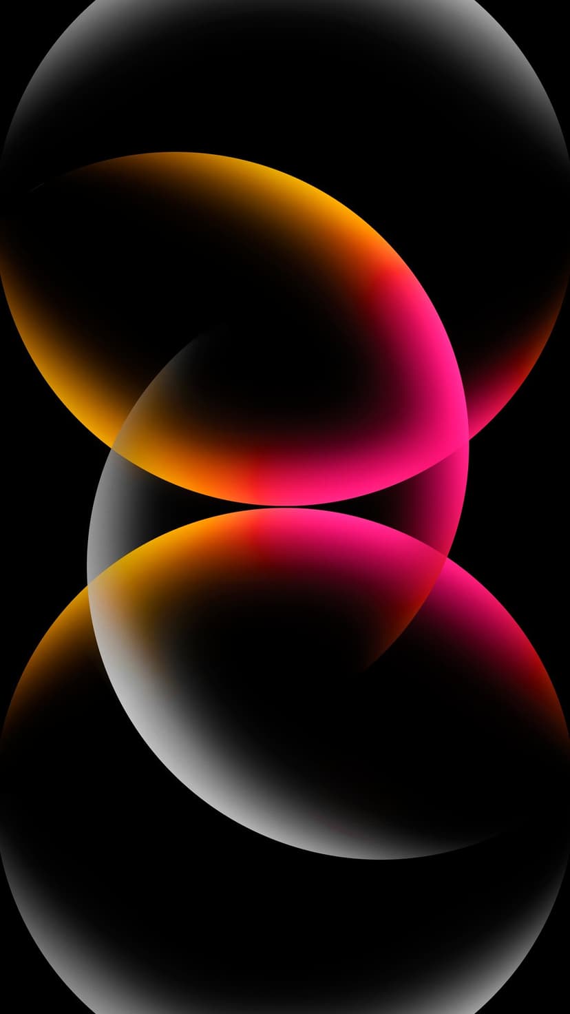 Translucent pink and orange spheres overlap against a black background with soft light reflections.