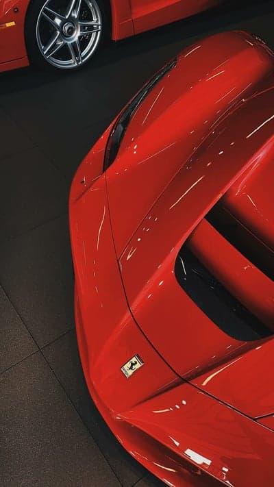 Sleek Red Ferrari Macro Detail High-Res Mobile Wallpaper